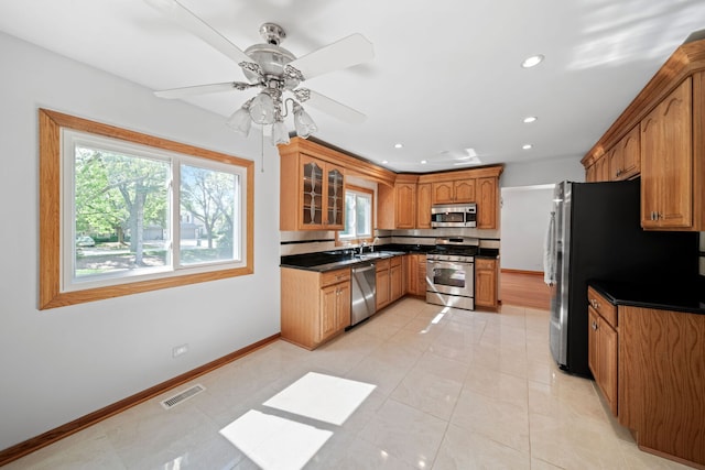 720 Dunhill Dr, Buffalo Grove, IL 60089 - kitchen featuring appliances with stainless steel finishes, brown cabinets, dark countertops, recessed lighting, and a ceiling fan
