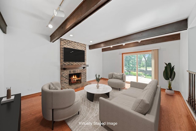 720 Dunhill Dr, Buffalo Grove, IL 60089 - living area with track lighting, beam ceiling, wood finished floors, and a fireplace