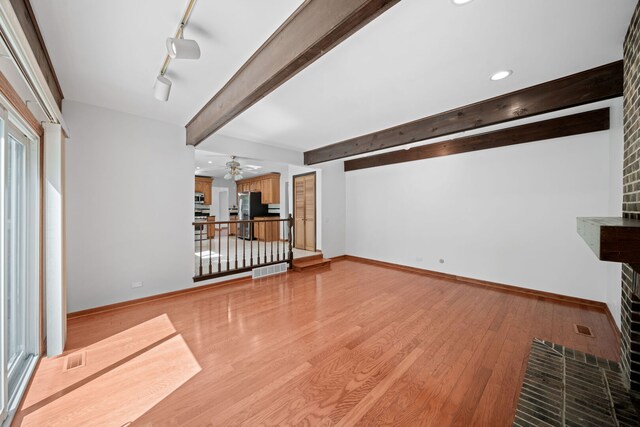 720 Dunhill Dr, Buffalo Grove, IL 60089 - unfurnished living room featuring ceiling fan, beamed ceiling, light wood-style flooring, recessed lighting, and track lighting