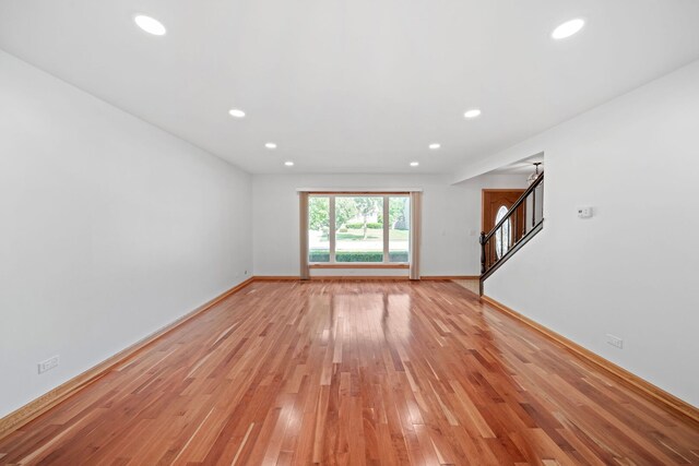 720 Dunhill Dr, Buffalo Grove, IL 60089 - unfurnished living room featuring light wood-style flooring, stairs, and recessed lighting