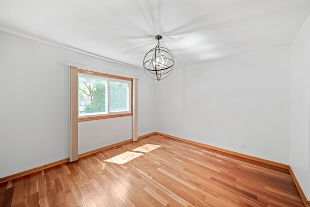 720 Dunhill Dr, Buffalo Grove, IL 60089 - empty room featuring a chandelier and light wood-style floors