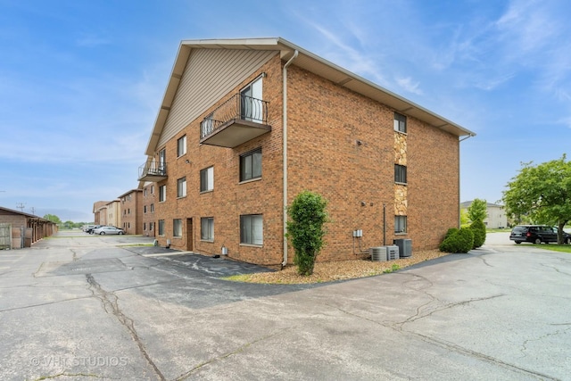 16807 81st Ave Unit 2S, Tinley Park, IL 60477 - view of building exterior featuring uncovered parking and central air condition unit