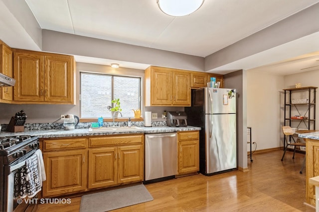 16807 81st Ave Unit 2S, Tinley Park, IL 60477 - kitchen featuring stainless steel appliances, a sink, light wood-style floors, and brown cabinets