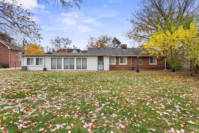 1456 Tyrell Ave, Park Ridge, IL 60068 - rear view of house featuring brick siding, a chimney, and central AC