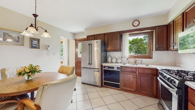 1510 W Goldengate Dr, Addison, IL 60101 - kitchen featuring stainless steel appliances, healthy amount of natural light, light countertops, and hanging light fixtures