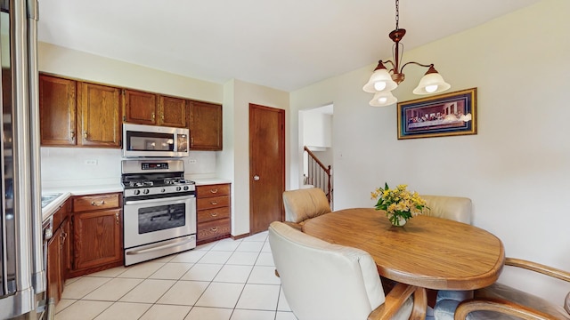 1510 W Goldengate Dr, Addison, IL 60101 - kitchen with stainless steel appliances, light countertops, pendant lighting, light tile patterned floors, and a chandelier