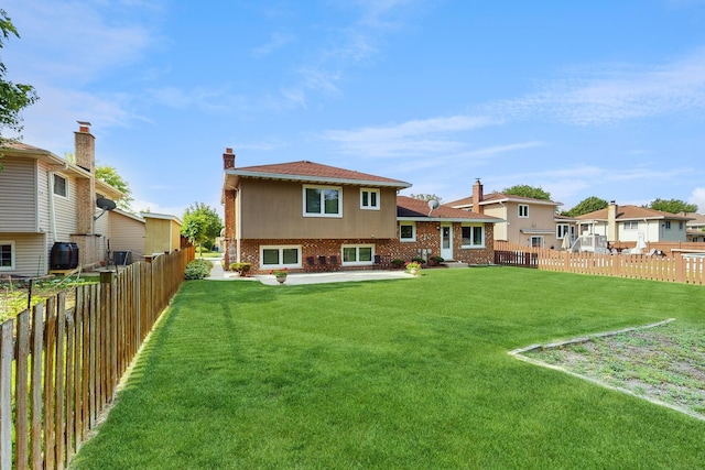 1510 W Goldengate Dr, Addison, IL 60101 - rear view of house with brick siding, a fenced backyard, a chimney, and a residential view