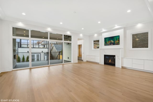 4242 N Winchester Ave, Chicago, IL 60613 - unfurnished living room featuring light wood-style flooring, a high end fireplace, recessed lighting, and baseboards