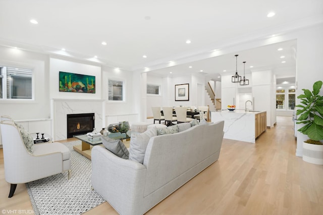 4242 N Winchester Ave, Chicago, IL 60613 - living area featuring stairs, recessed lighting, light wood-style flooring, and a premium fireplace