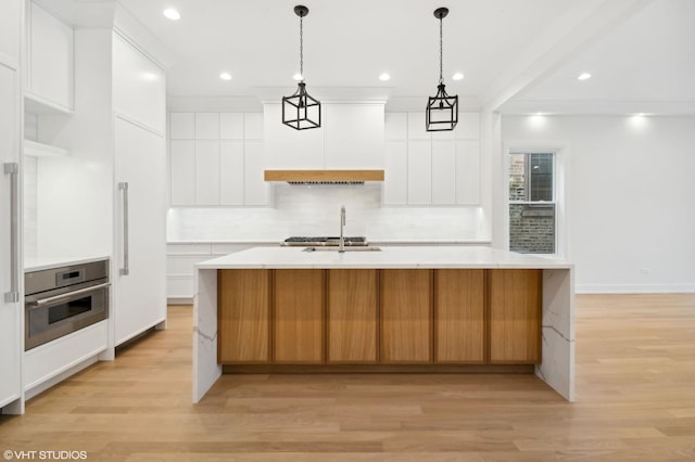 4242 N Winchester Ave, Chicago, IL 60613 - kitchen with stainless steel oven, a sink, light wood-style flooring, backsplash, and recessed lighting