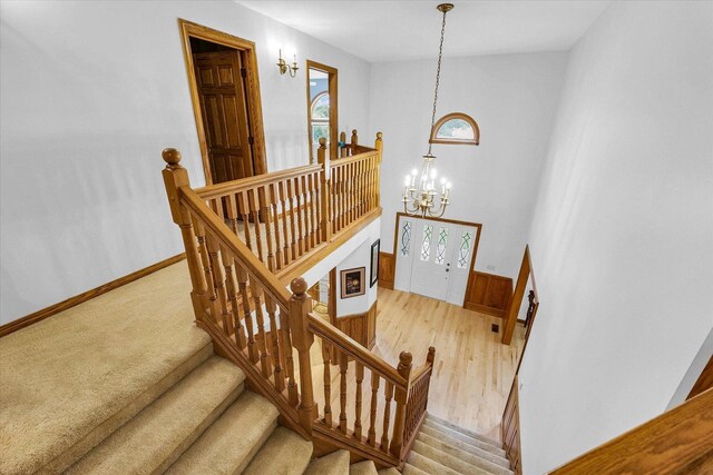 1206 Wilshire Ct, Champaign, IL 61821 - staircase featuring a chandelier and baseboards