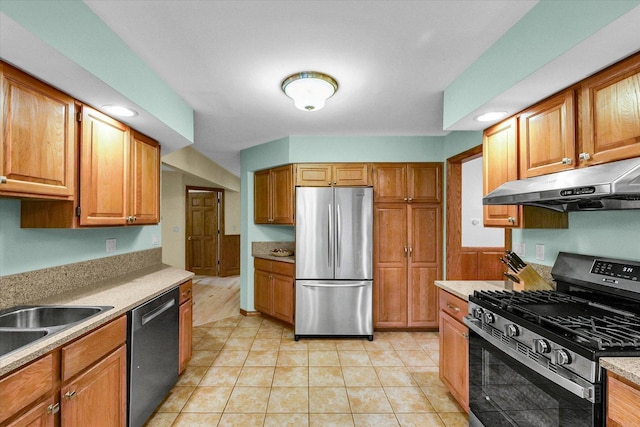 1206 Wilshire Ct, Champaign, IL 61821 - kitchen featuring stainless steel appliances, under cabinet range hood, light countertops, light tile patterned floors, and a sink
