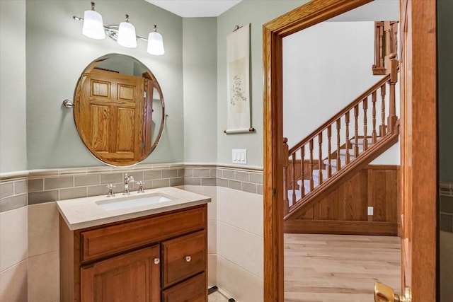 1206 Wilshire Ct, Champaign, IL 61821 - bathroom featuring vanity, tile walls, a wainscoted wall, and wood finished floors