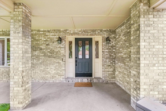 1206 Wilshire Ct, Champaign, IL 61821 - property entrance featuring brick siding and a porch