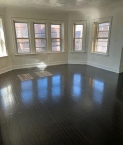 7921 S Hermitage Ave, Chicago, IL 60620 - empty room with baseboards and dark wood-type flooring