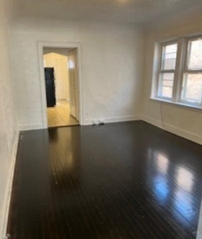 7921 S Hermitage Ave, Chicago, IL 60620 - spare room featuring wood finished floors and baseboards