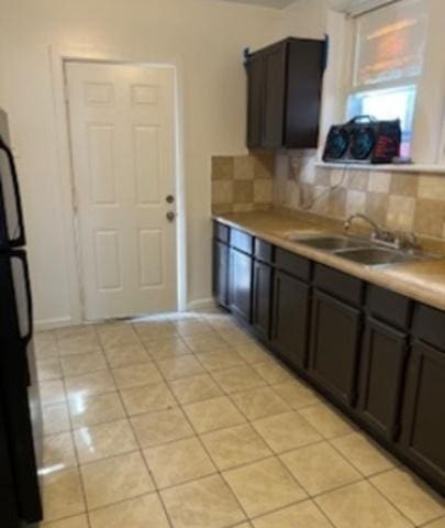 7921 S Hermitage Ave, Chicago, IL 60620 - kitchen featuring a sink, tasteful backsplash, light countertops, and light tile patterned flooring