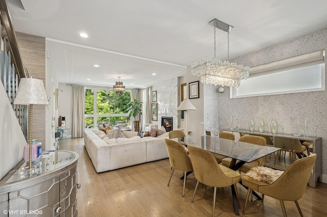 3731 W Lyndale St, Chicago, IL 60647 - dining space with a chandelier, a large fireplace, wood finished floors, stairs, and recessed lighting