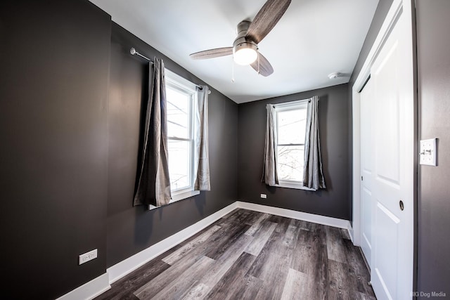 820 E 74th St, Chicago, IL 60619 - unfurnished bedroom featuring a closet, baseboards, dark wood-style flooring, and a ceiling fan