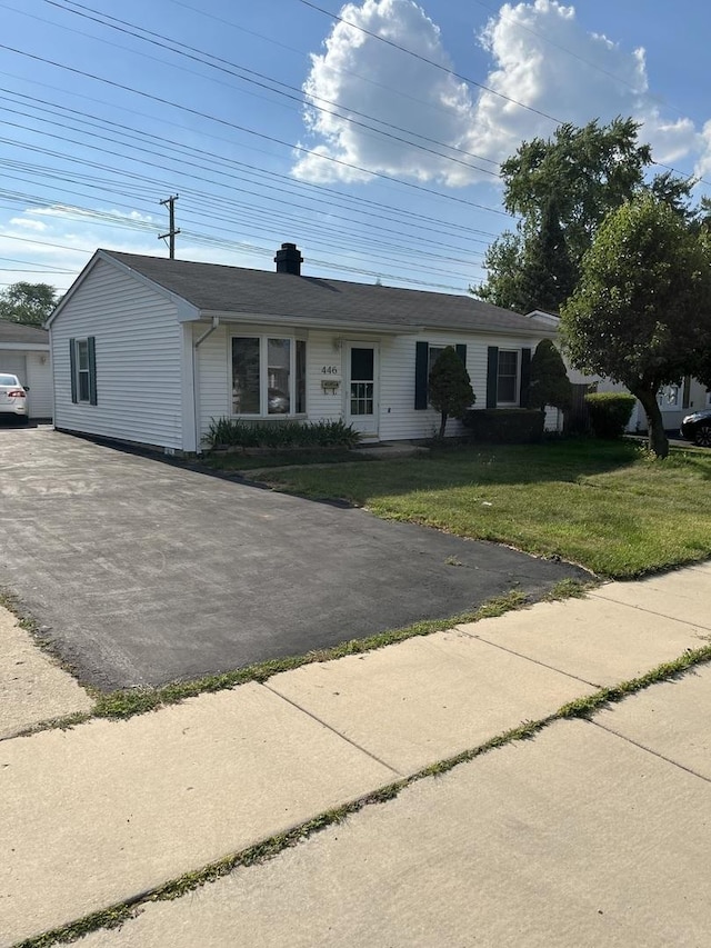 446 Montrose Dr, Romeoville, IL 60446 - ranch-style house featuring a front yard, asphalt driveway, and a chimney