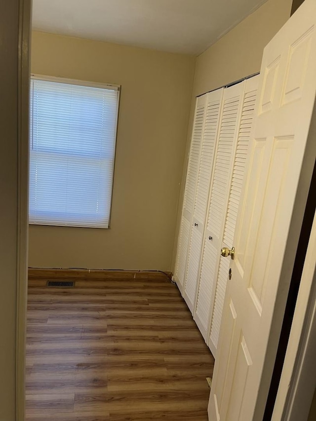 446 Montrose Dr, Romeoville, IL 60446 - unfurnished bedroom featuring dark wood-type flooring and a closet