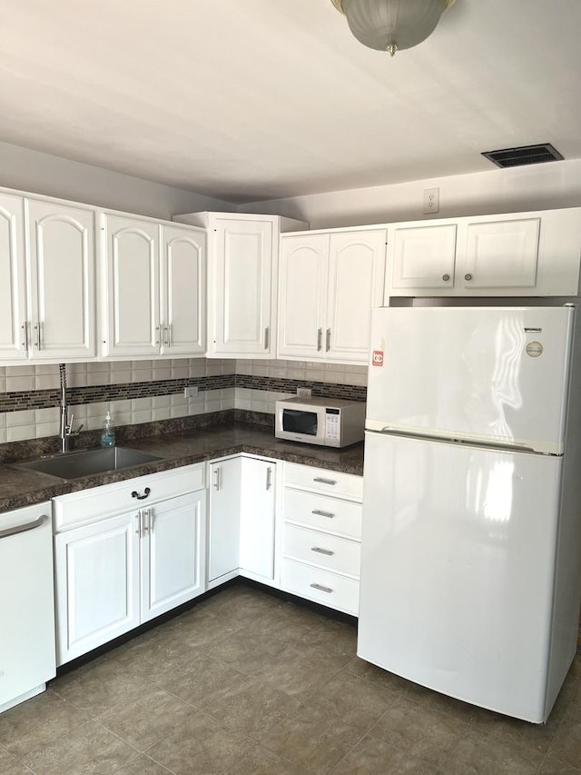 446 Montrose Dr, Romeoville, IL 60446 - kitchen featuring white appliances, white cabinets, and dark countertops