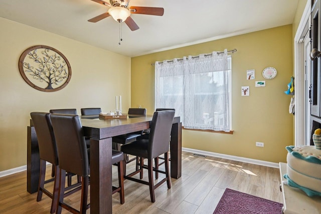 1043 San Mateo Dr, Romeoville, IL 60446 - dining room featuring ceiling fan, wood finished floors, and baseboards