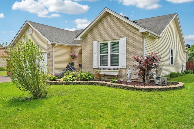 1043 San Mateo Dr, Romeoville, IL 60446 - view of front of house with a garage, brick siding, a shingled roof, and a front lawn