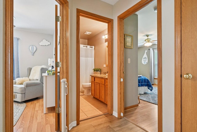 1043 San Mateo Dr, Romeoville, IL 60446 - hallway featuring light wood-type flooring and baseboards