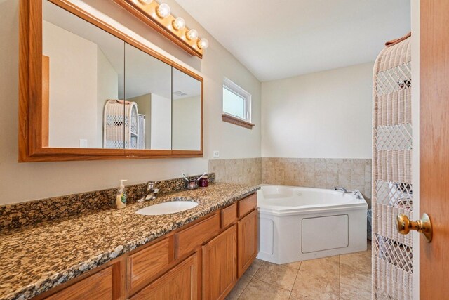 1043 San Mateo Dr, Romeoville, IL 60446 - bathroom featuring vanity, a garden tub, and tile patterned flooring