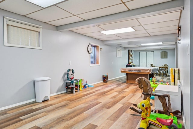 1043 San Mateo Dr, Romeoville, IL 60446 - rec room with a paneled ceiling, wood finished floors, and baseboards