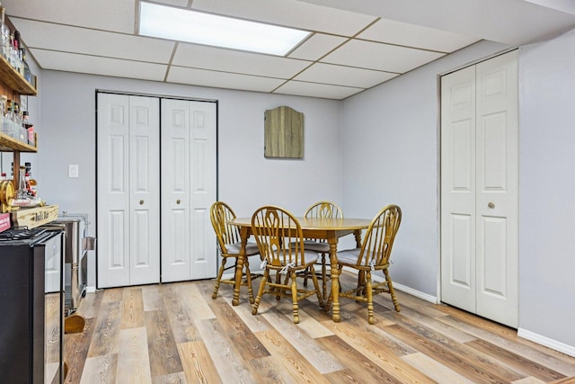 1043 San Mateo Dr, Romeoville, IL 60446 - dining space featuring light wood finished floors, a drop ceiling, and baseboards