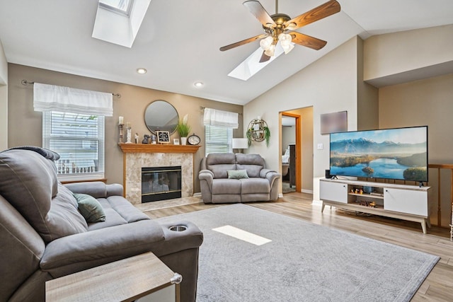 1043 San Mateo Dr, Romeoville, IL 60446 - living room with a skylight, lofted ceiling, ceiling fan, a high end fireplace, and wood finished floors