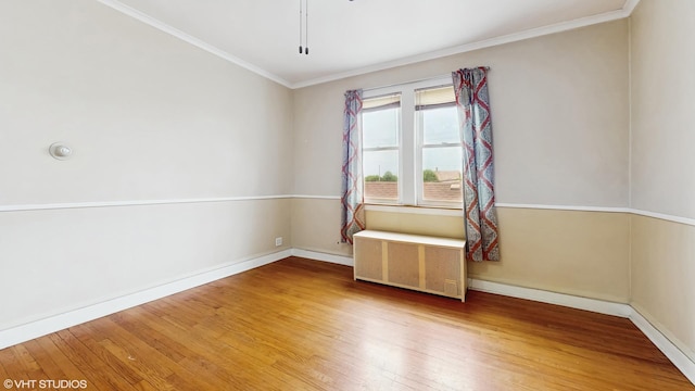 4608 W Altgeld St, Chicago, IL 60639 - spare room featuring radiator, wood finished floors, baseboards, and ornamental molding