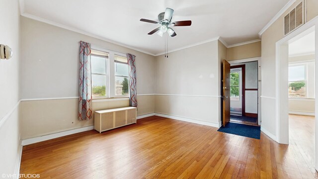 4608 W Altgeld St, Chicago, IL 60639 - spare room featuring radiator, light wood-style flooring, plenty of natural light, a ceiling fan, and ornamental molding