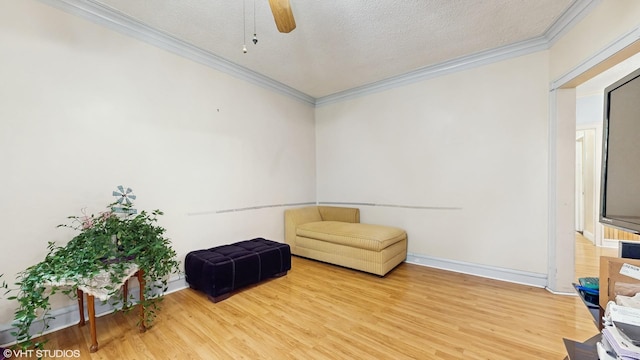 4608 W Altgeld St, Chicago, IL 60639 - sitting room with crown molding, light wood finished floors, a ceiling fan, a textured ceiling, and baseboards