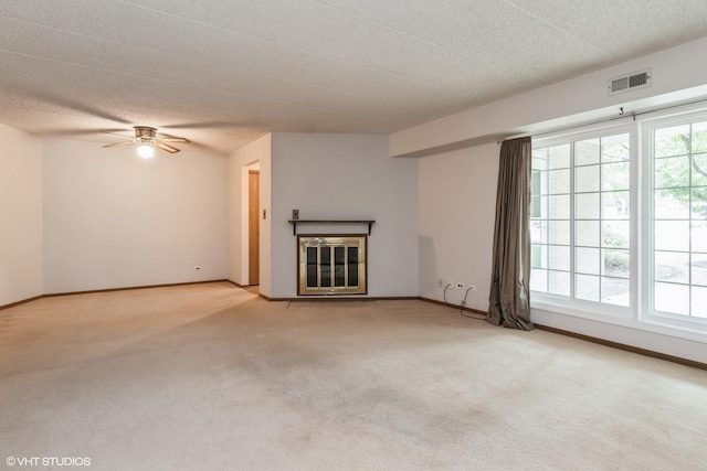 1258 Chalet Rd Unit 101, Naperville, IL 60563 - unfurnished living room with carpet floors, a glass covered fireplace, a ceiling fan, and a textured ceiling
