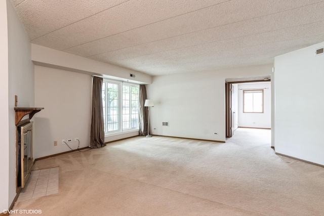1258 Chalet Rd Unit 101, Naperville, IL 60563 - unfurnished living room with light colored carpet, a fireplace, and plenty of natural light