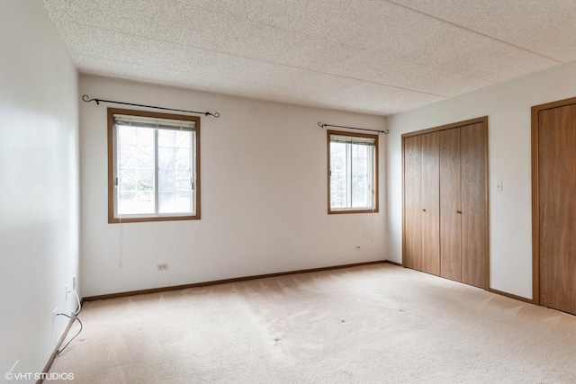 1258 Chalet Rd Unit 101, Naperville, IL 60563 - unfurnished bedroom with light colored carpet and two closets