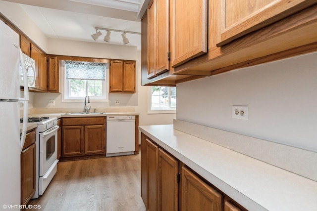 1258 Chalet Rd Unit 101, Naperville, IL 60563 - kitchen with white appliances, light wood-style floors, brown cabinetry, and light countertops