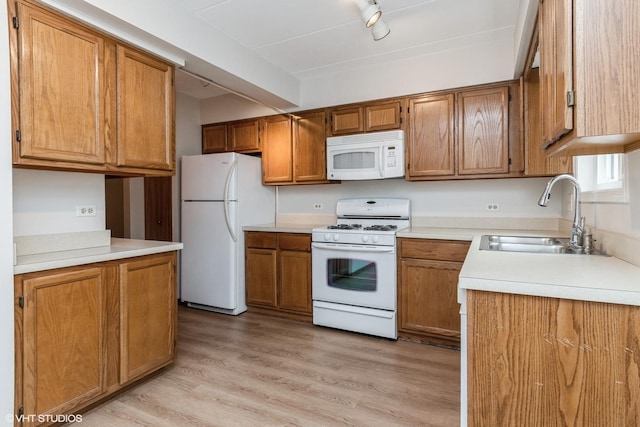 1258 Chalet Rd Unit 101, Naperville, IL 60563 - kitchen with white appliances, brown cabinetry, light countertops, and light wood-type flooring