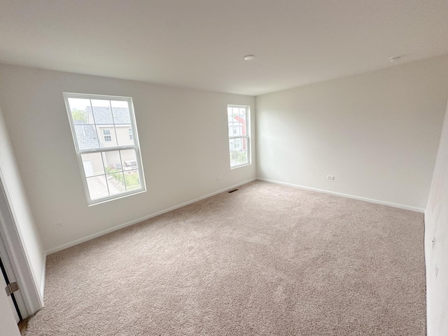 993 Celebration Dr, Aurora, IL 60504 - unfurnished room featuring healthy amount of natural light, carpet flooring, and baseboards