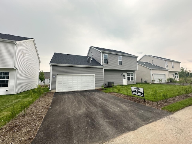 993 Celebration Dr, Aurora, IL 60504 - colonial home featuring driveway, a front yard, an attached garage, and cooling unit