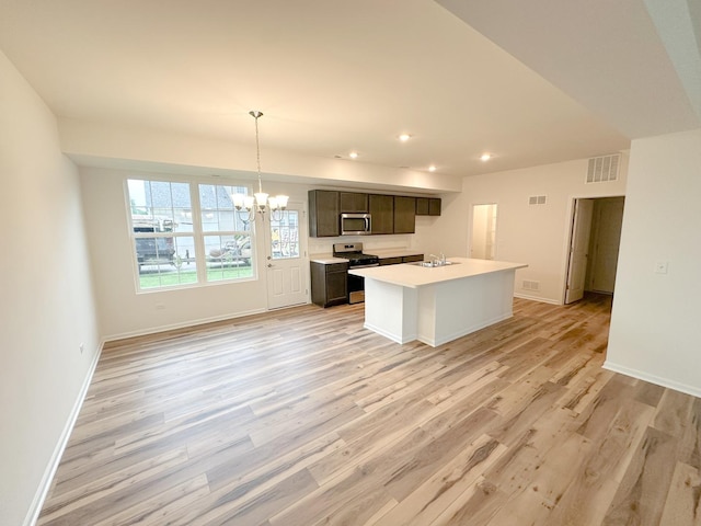 993 Celebration Dr, Aurora, IL 60504 - kitchen featuring stainless steel appliances, a sink, recessed lighting, light wood-style floors, and a chandelier