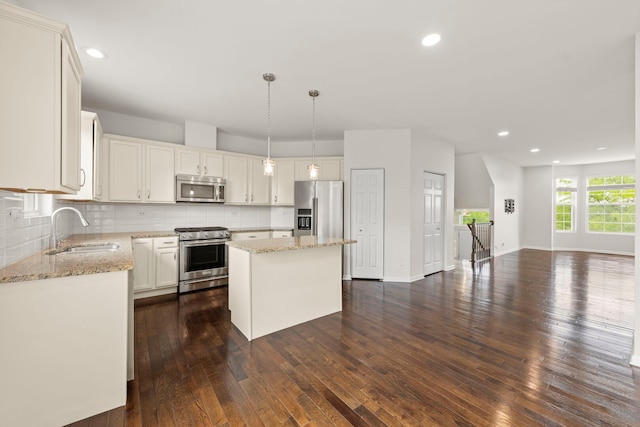 10615 W 153rd St, Orland Park, IL 60462 - kitchen featuring appliances with stainless steel finishes, a sink, light stone counters, dark wood-style flooring, and recessed lighting