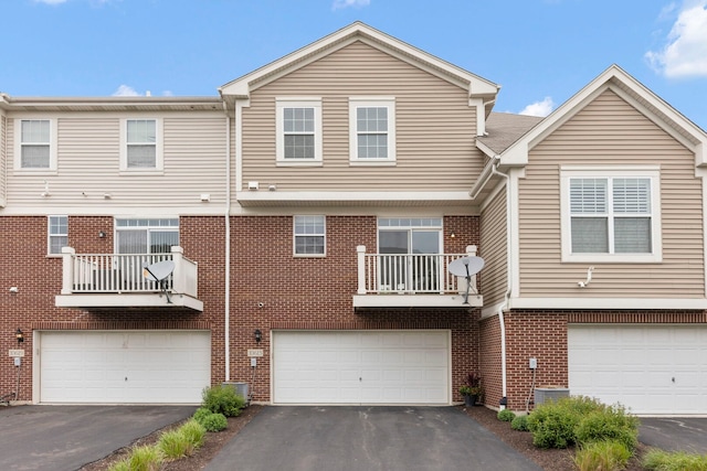 10615 W 153rd St, Orland Park, IL 60462 - back of house featuring driveway, a garage, brick siding, and a balcony