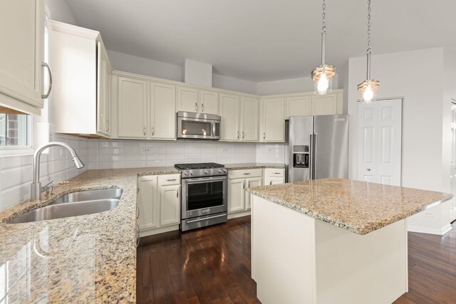 10615 W 153rd St, Orland Park, IL 60462 - kitchen featuring high end appliances, a sink, dark wood finished floors, light stone countertops, and a kitchen island