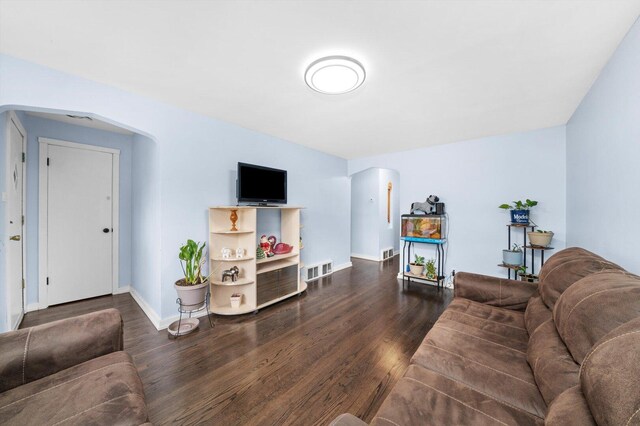 1723 W 75th Pl, Chicago, IL 60620 - living room with dark wood-type flooring, baseboards, and arched walkways