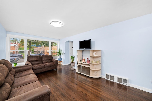 1723 W 75th Pl, Chicago, IL 60620 - living area with arched walkways, dark wood-style flooring, and baseboards