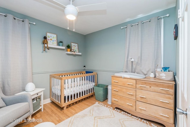 490 W Crystal Lake Ave, Crystal Lake, IL 60014 - bedroom with a nursery area, light wood-style flooring, and ceiling fan